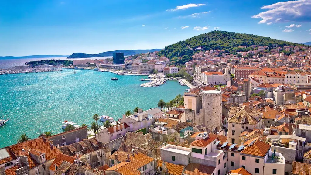 Stone houses and terracotta rooftops of Split's Veli Varoš quarter climbing towards Marjan Hill