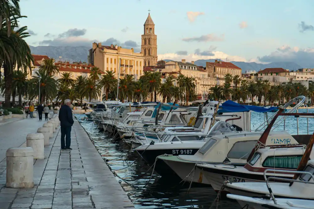 Sailing boats moored in Split's harbour beneath a clear sky