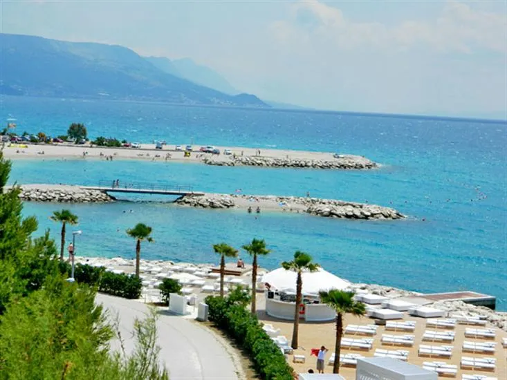Family friendly beach and shallow turquoise water on the coast near Split, Croatia
