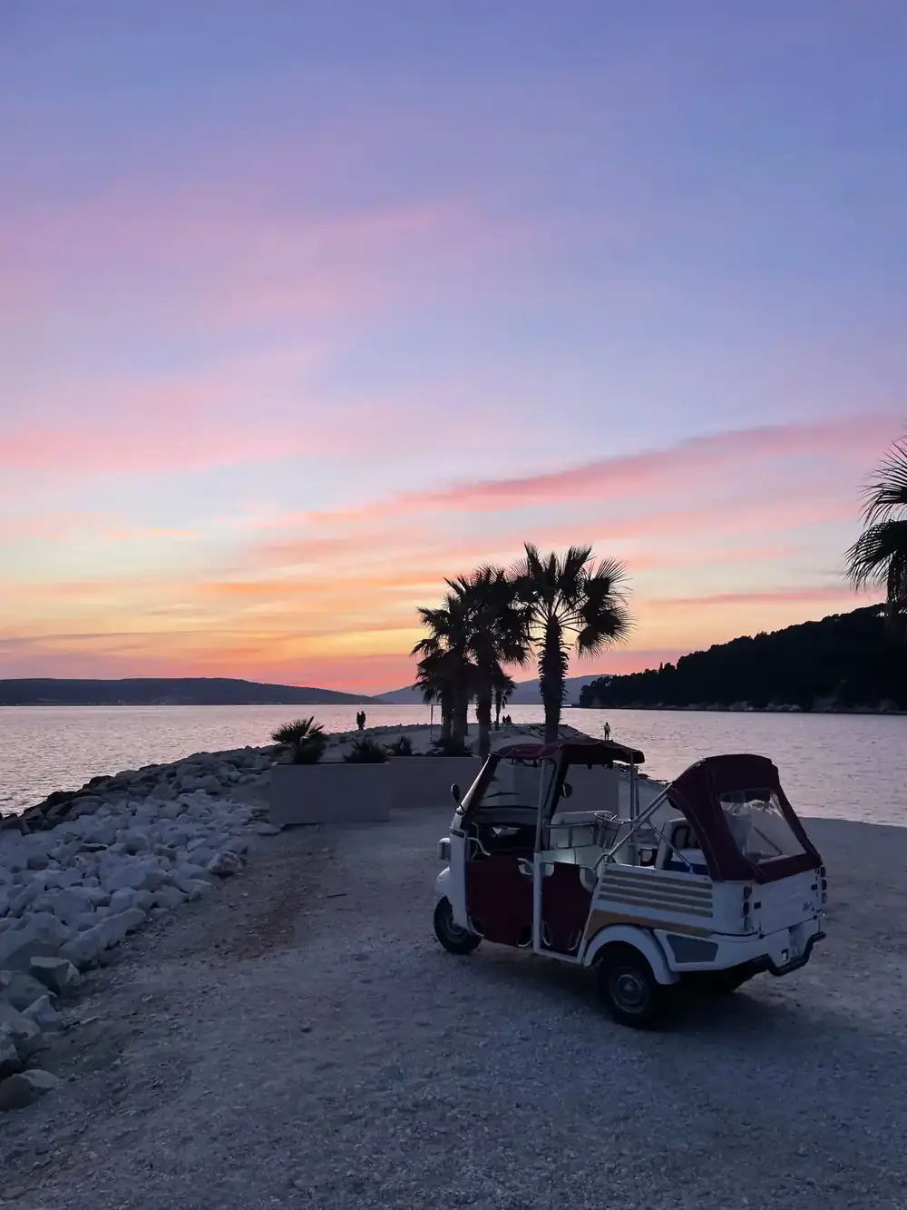 Guests on the Romantic Night Ride tuk tuk tour through Split at dusk