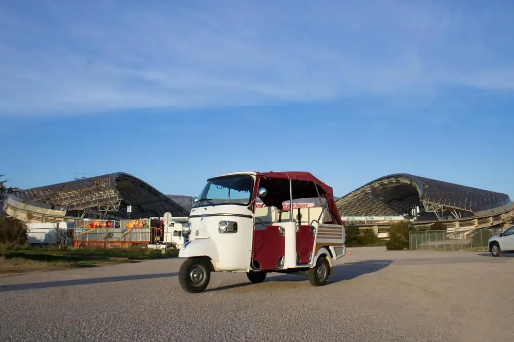 Friends laughing together during a tuk tuk ride along the coast