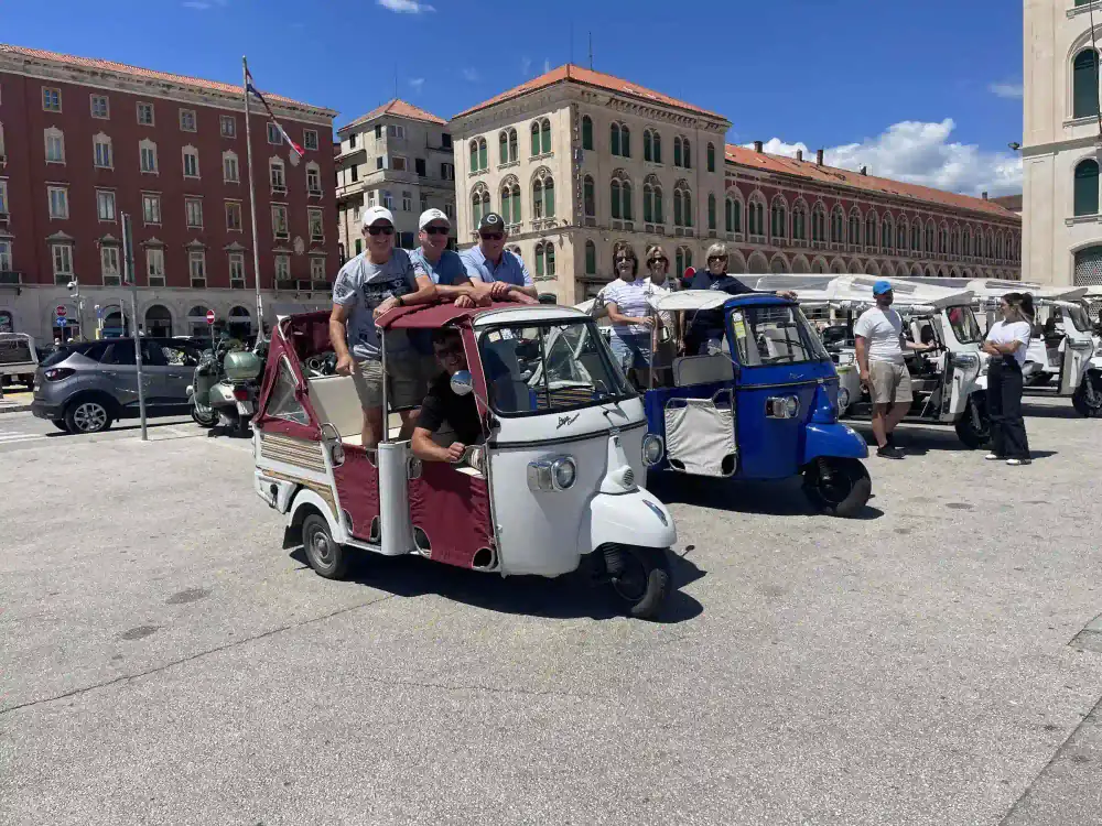 Passengers toasting the view on a Split tuk tuk excursion