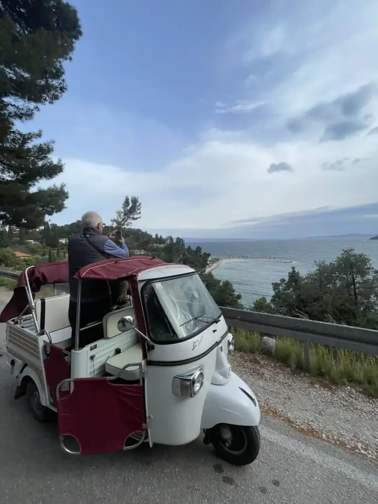 Two friends framed by the tuk tuk with Split behind them
