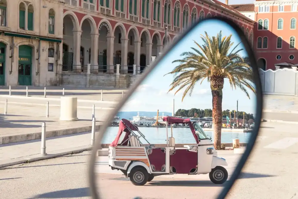 Travellers enjoying the open-air ride on a Retro Tuk tour through Split