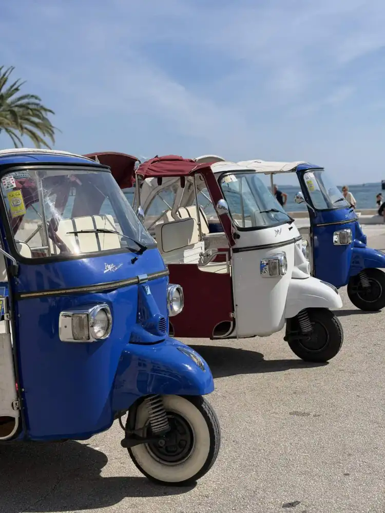 The retro tuk tuk rolling along Split's palm-lined waterfront
