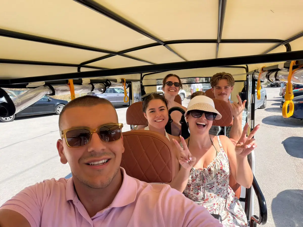 Smiling guests taking a selfie under the roof of a tuk tuk in Split