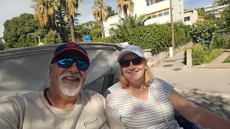 A couple taking a selfie in the back of a tuk tuk in Split