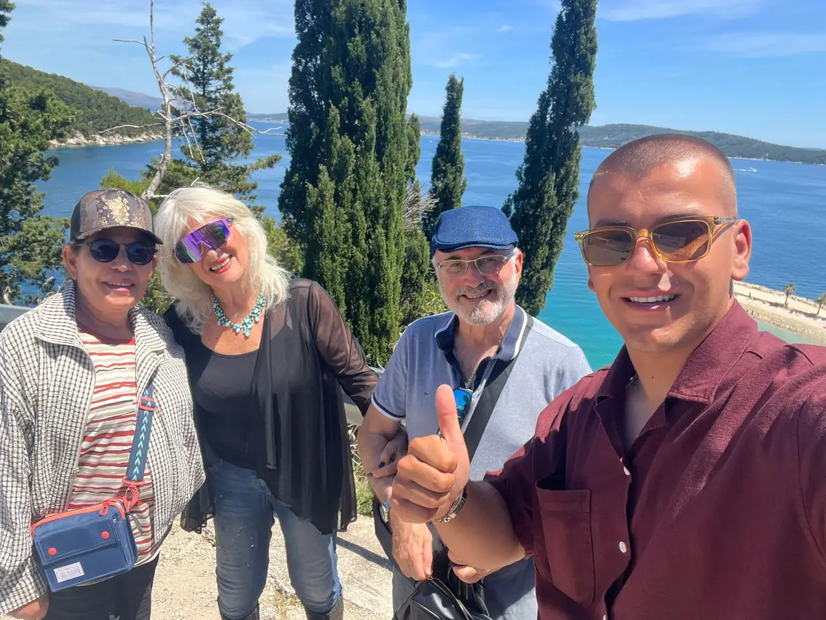 Guide and guests taking a selfie above the turquoise sea on Marjan Hill
